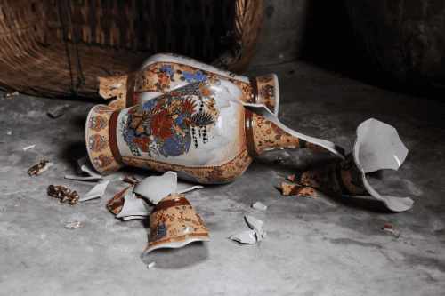 Broken antique vase on the ground
